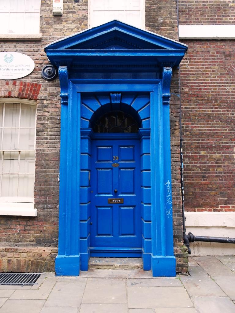 Blue door and fine portico, Fournier Street, London, April 2019