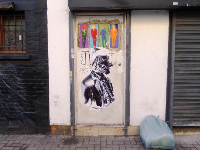 Wheatpasted door, Face the Strange (top) and CodeFC (bottom), Camden Town, November 2017