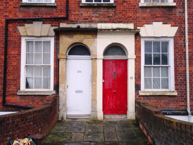 Red and white door (the colours of Bristol City football club), Hotwells, Bristol, March 2019