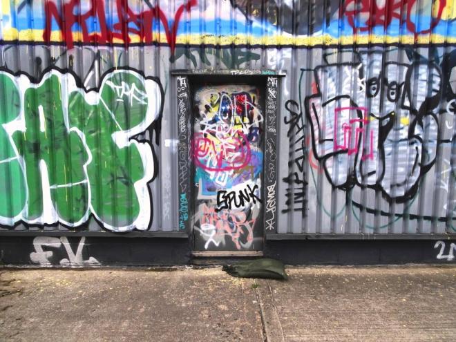 Charmingly decorated fire exit door to a warehouse, River Avon cycle path, Bristol, June 2019
