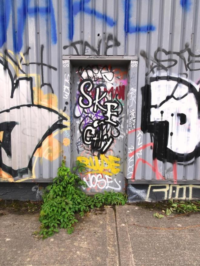 Charmingly decorated fire exit door to a warehouse, River Avon cycle path, Bristol, June 2019