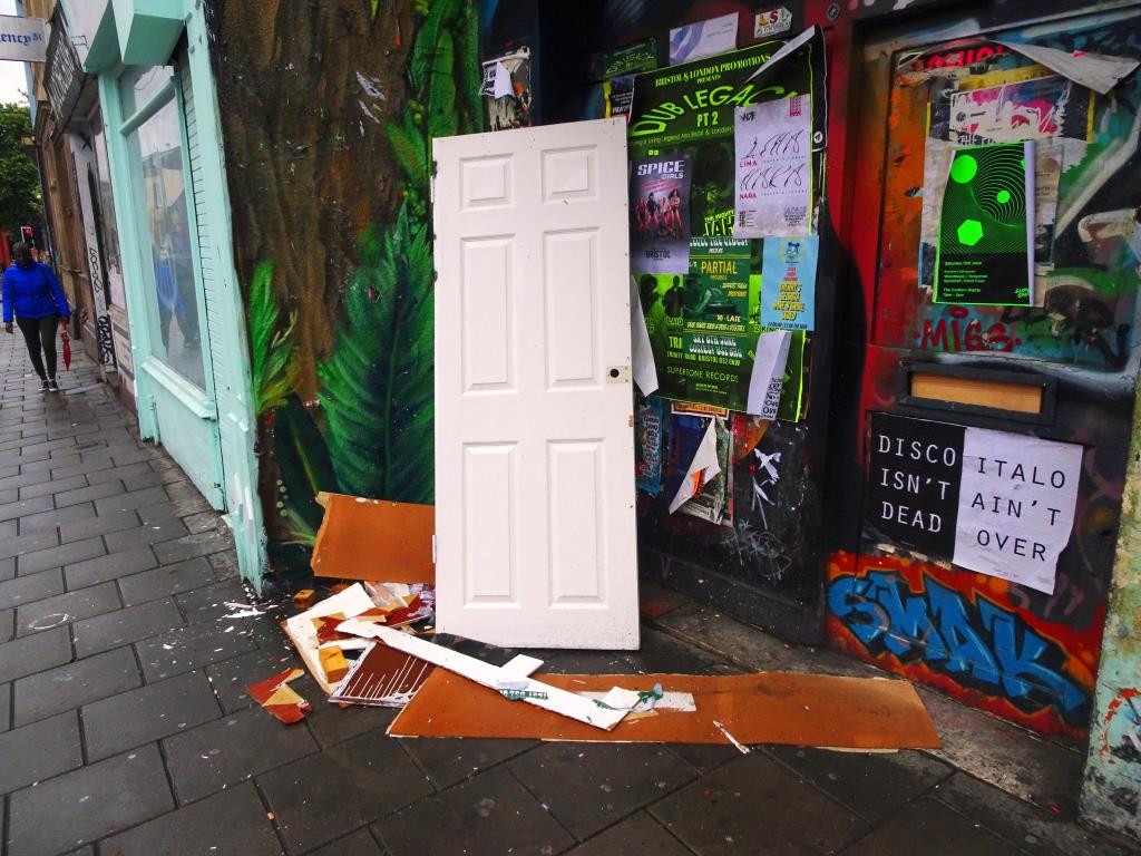 Is this the same abandoned door? and can you see the door behind all the posters? Stokes Croft, Bristol, June 2019