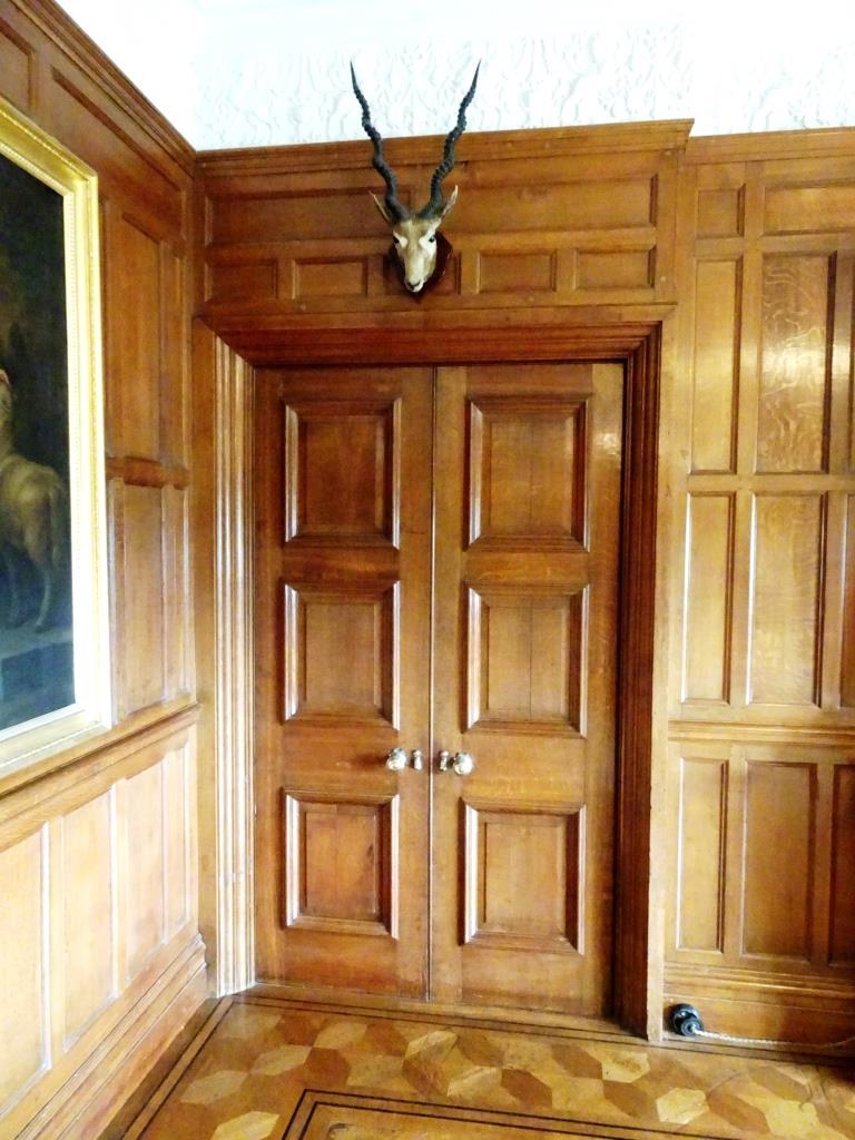 Doors and trophy, Lanhydrock House, Cornwall, August 2019