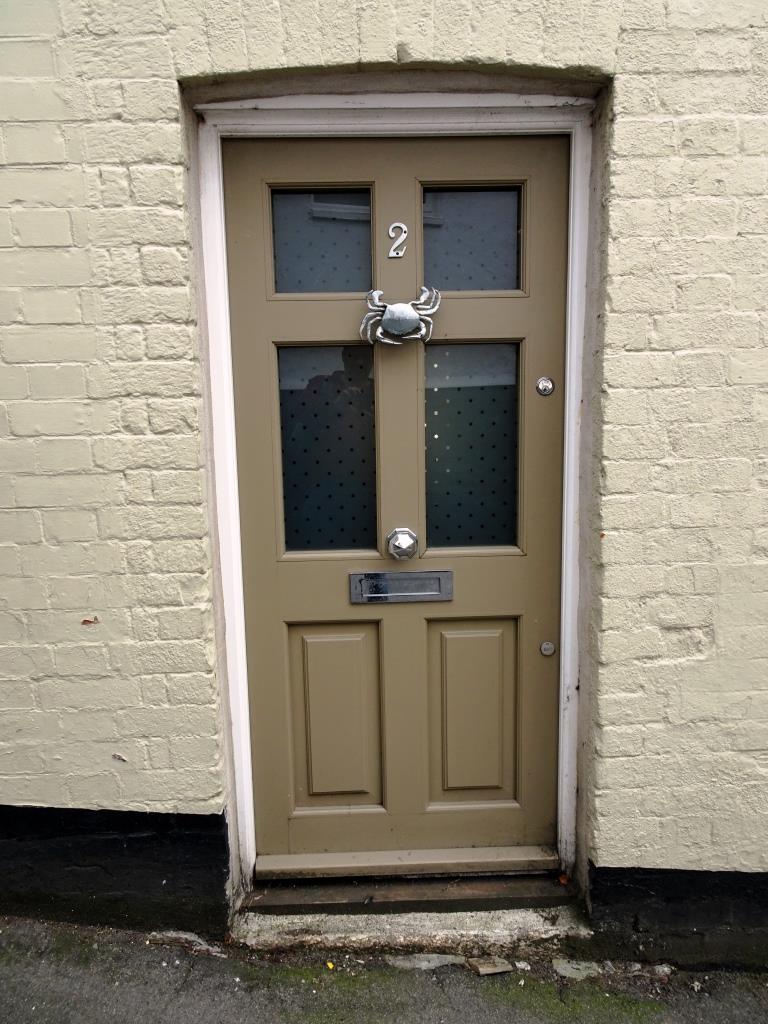 Brown door with a crab knocker, Fowey, Cornwall, September 2019