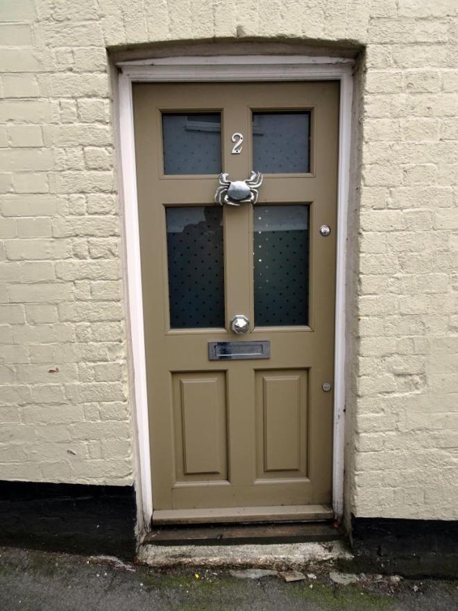 Brown door with a crab knocker, Fowey, Cornwall, September 2019