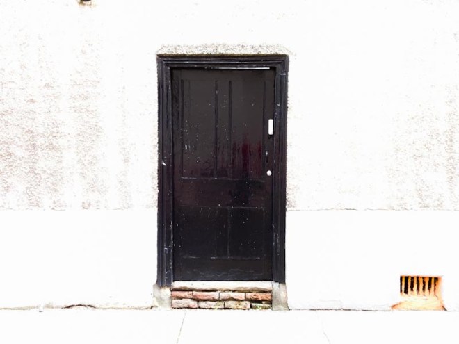 Blacl door on a bleached out background - it must have been a bright day, Bristol, October 2020