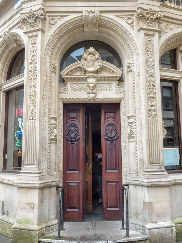 Carved wooden door and ornate surround, Clare Street, Bristol, March 2021