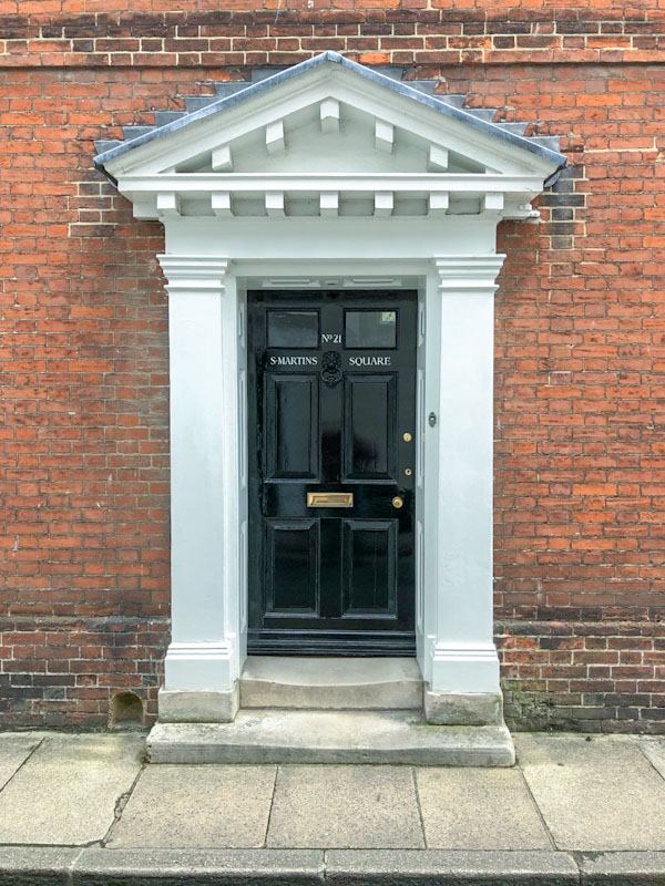 Large awning and worn steps on this door with boot scraper to the left, Chichester, May 2021
