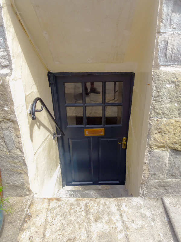 Steps down to a low door and foot doorfie, Lyme Regis, Dorset, August 2021