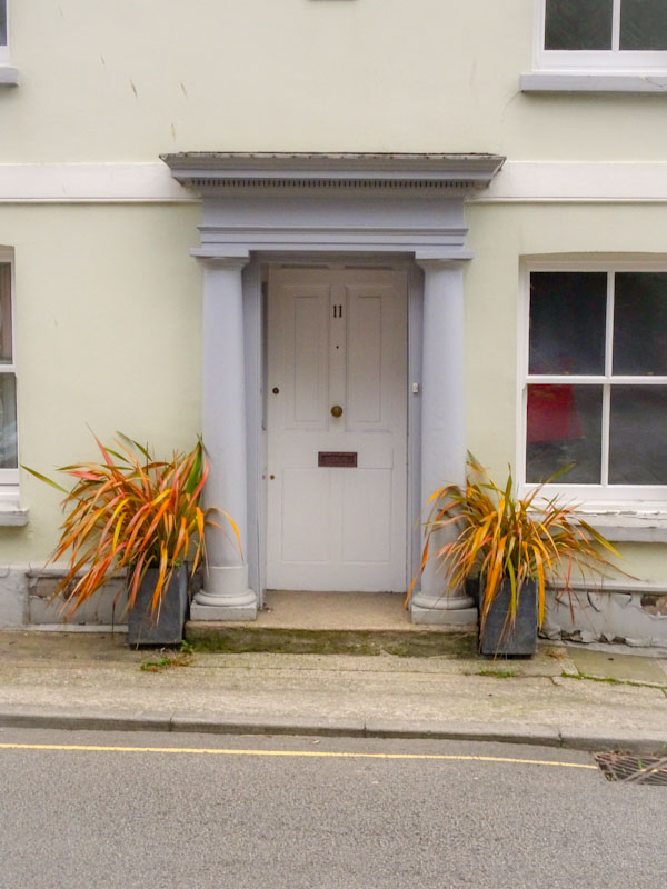 Door with portico and plant pots, Liskeard, Cornwall, August 2021