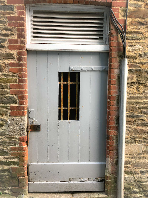 Door with iron grille, Looe, Cornwall, October 2021