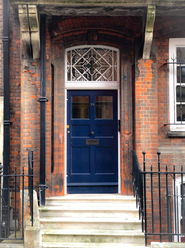 Blue door with white iron work above, Westminster, London, April 2022