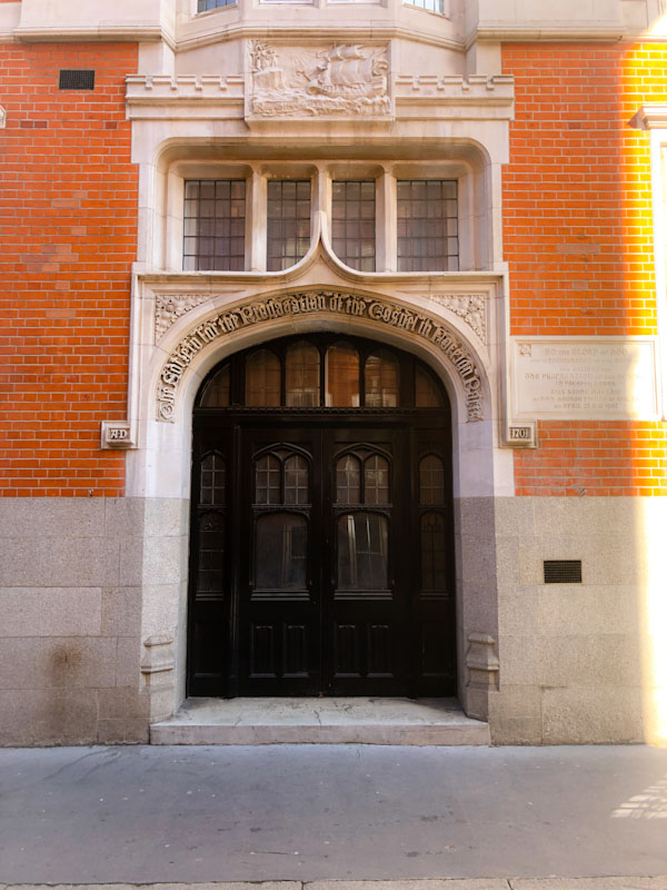 Ecliastical door with castellated surround, Westminster, London, April 2022