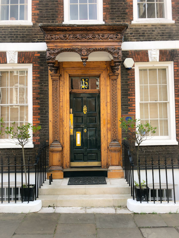 An extraordinary door and carved wooden surround and awning, Westminster, London, May 2022