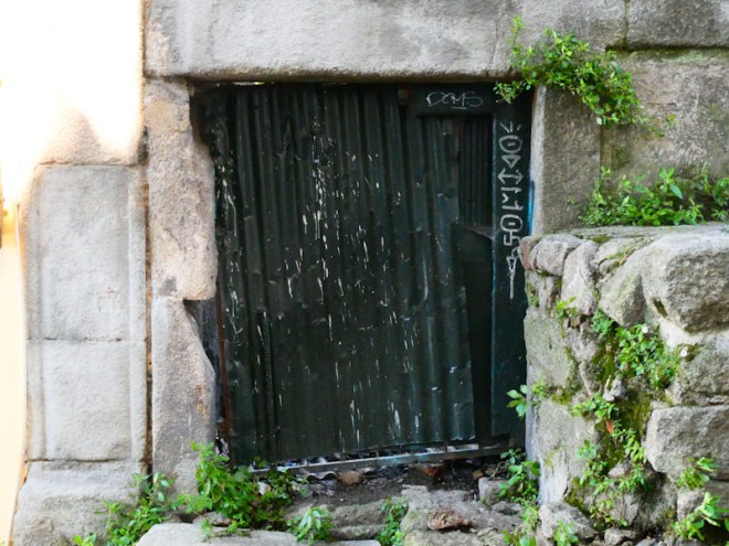 small black corrugated iron door, Porto, Portugal, June 2022
