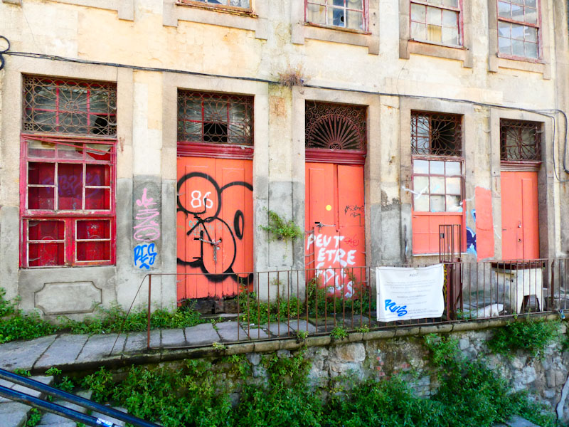 Three doors on a disused warehouse building, Porto, Portugal, June 2022