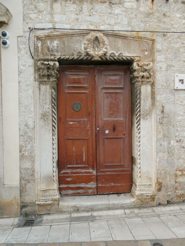 Ancient doorway with less ancient door, Zadar, Croatia, August 2022