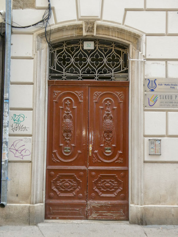 Ornate double door, Pula, Croatia, August 2023