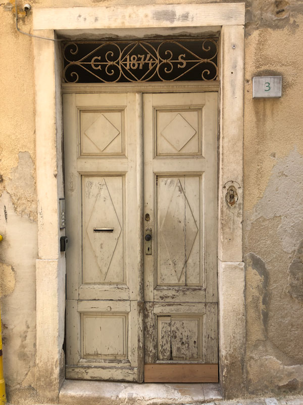 1874 doorway and wooden doors, Pula, Croatia, August 2023
