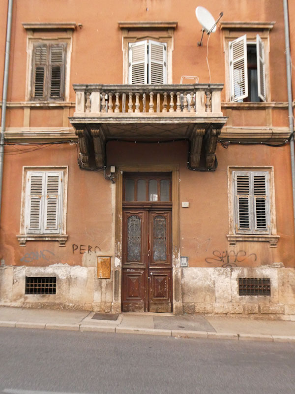 Fancy doors and ballustraded balcony, Pula, Croatia, August 2023