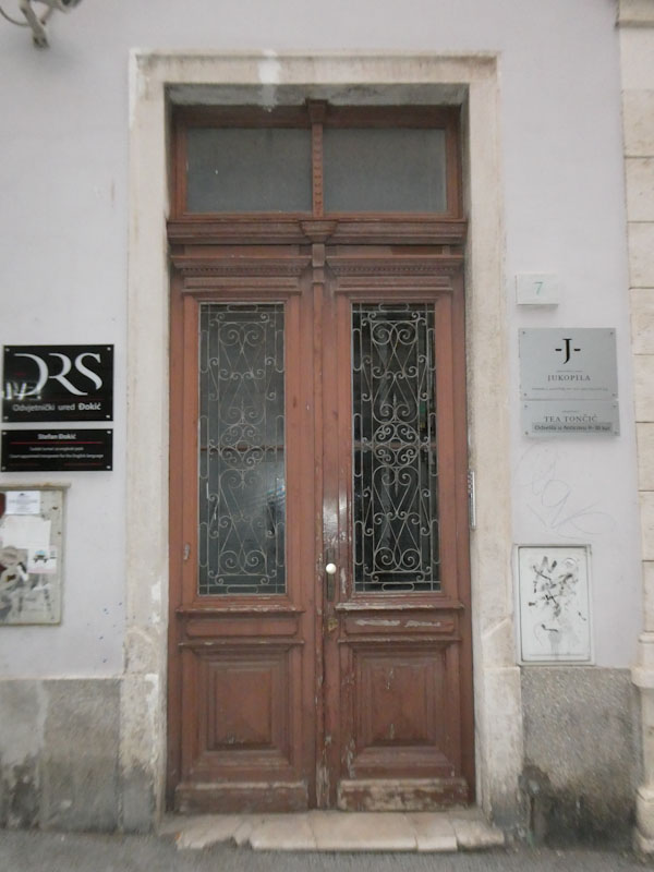 Doors with glass panels and fine ironwork, Pula, Croatia, August 2023