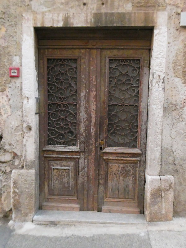 Wide doors with glass and ironwork, Croatia, August 2023