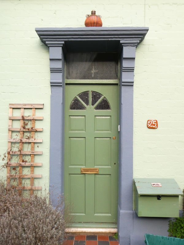Green door with a bottle on the cornice, Greenbank, Bristol, February 2023