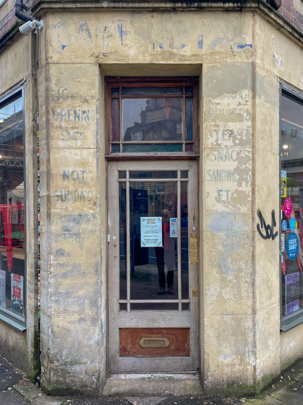 It is the writing around the door that tells you something about a previous life of the building, Old Market, Bristol, May 2023