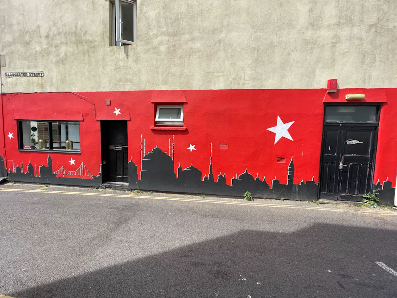 Black doors on the side of a restaurant, Weston-super-Mare, May 2023