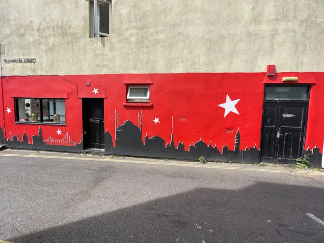 Black doors on the side of a restaurant, Weston-super-Mare, May 2023