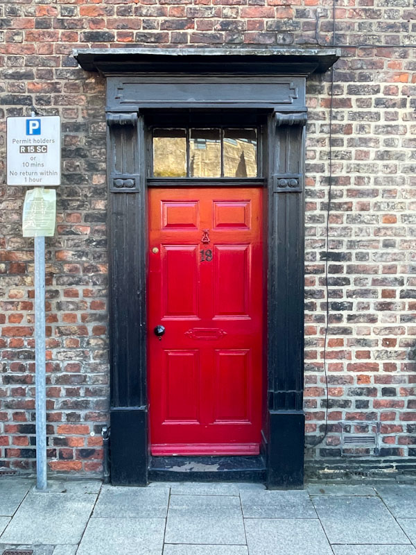 Pillar box red door with black surround, York, June 2023