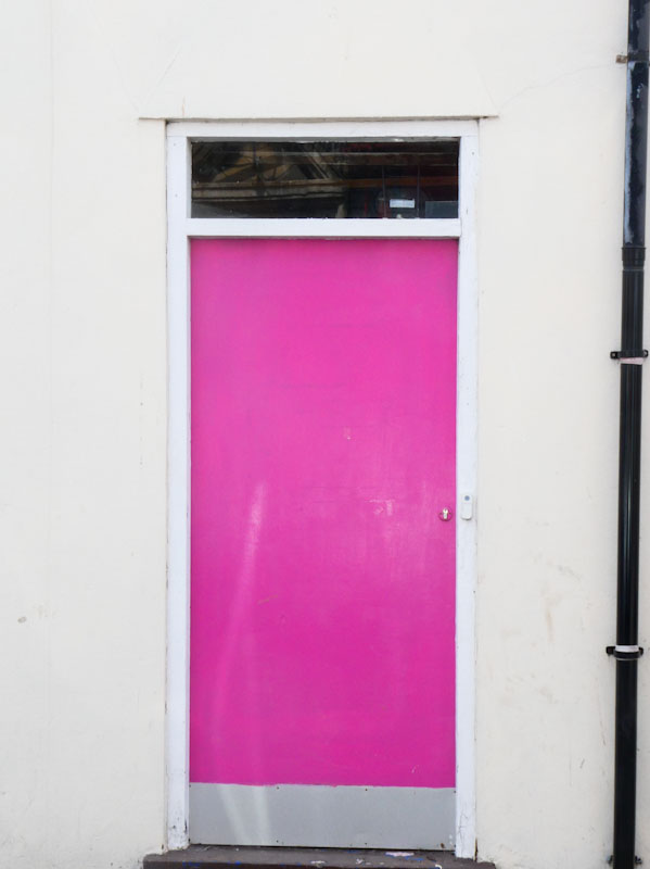 Pink door with kick-plate, Weston-super-Mare, May 2023