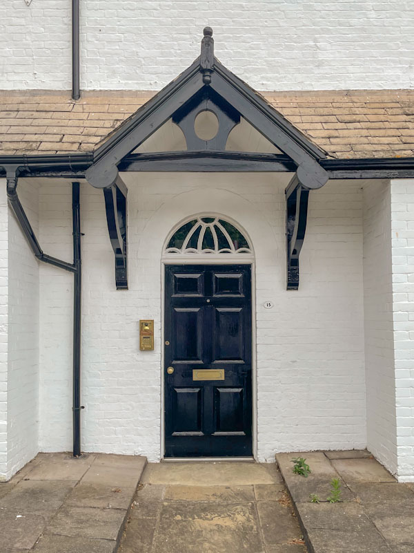 Black door with fan light and gable, Lincoln July 2023