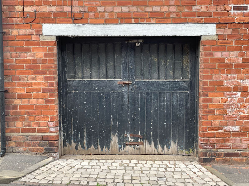 Classic garage door with plenty of bolts and locks , Lincoln, June 2023