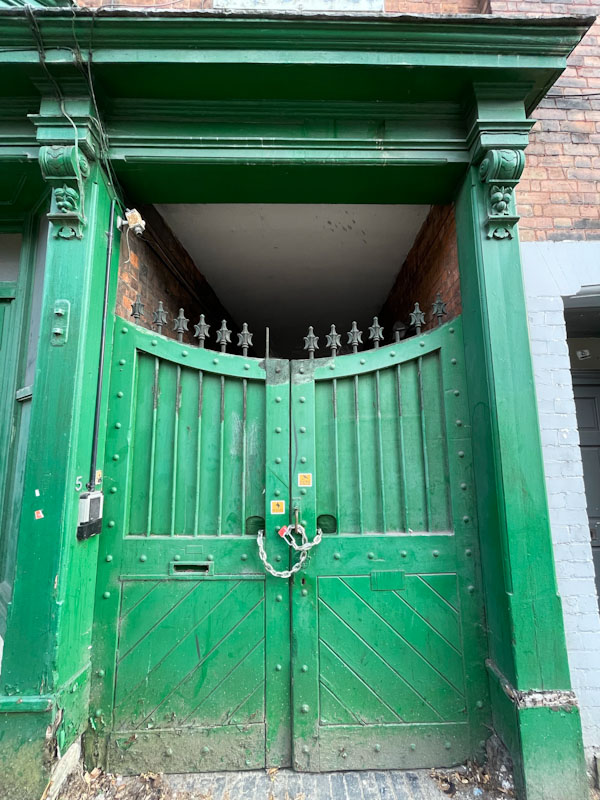 Green gates and doorway, Lincoln, June 2023