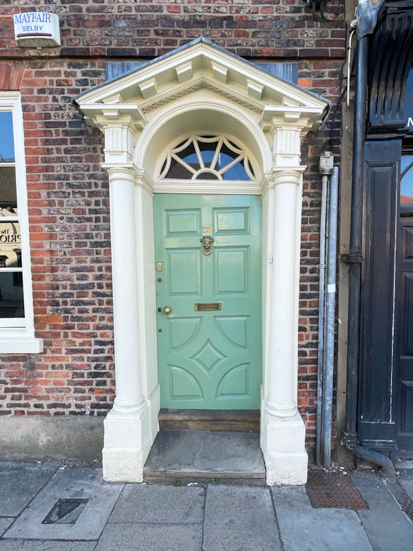 Slightly wonky light green door and beautiful Portico, York, June 2023