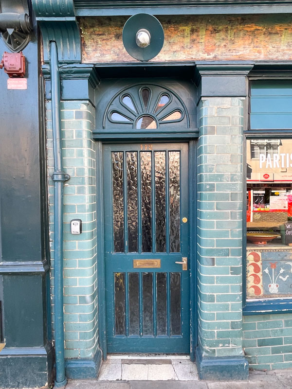 Wooden framed glass door and brick tiles, York, June 2023