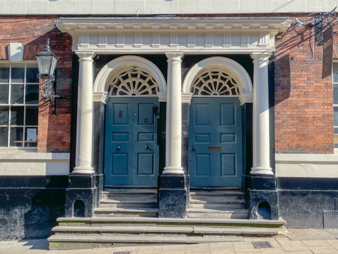 Double doorway with columns and portico and indentations for the boot scrapers, York, June 2023