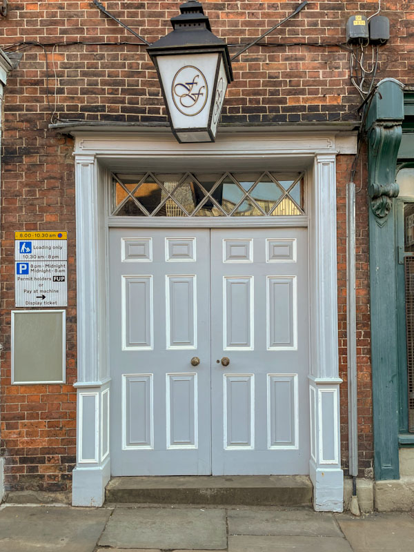Double panelled door with wooden frame, York, June 2023