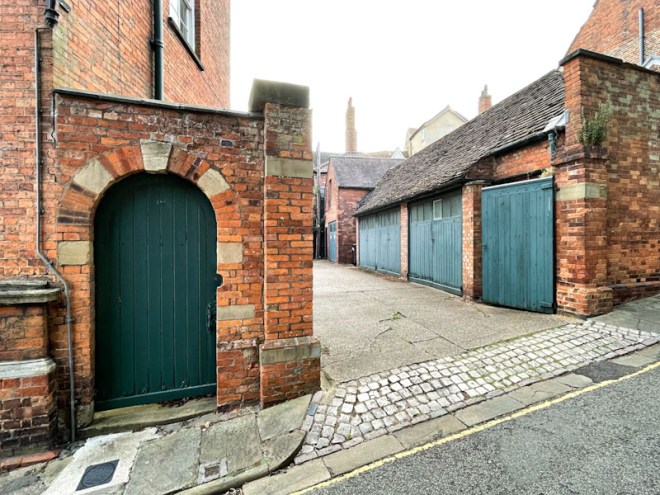 Green gate and garage doors, Lincoln, July 2023