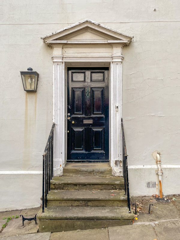 Black door and steps, Lincoln, July 2023