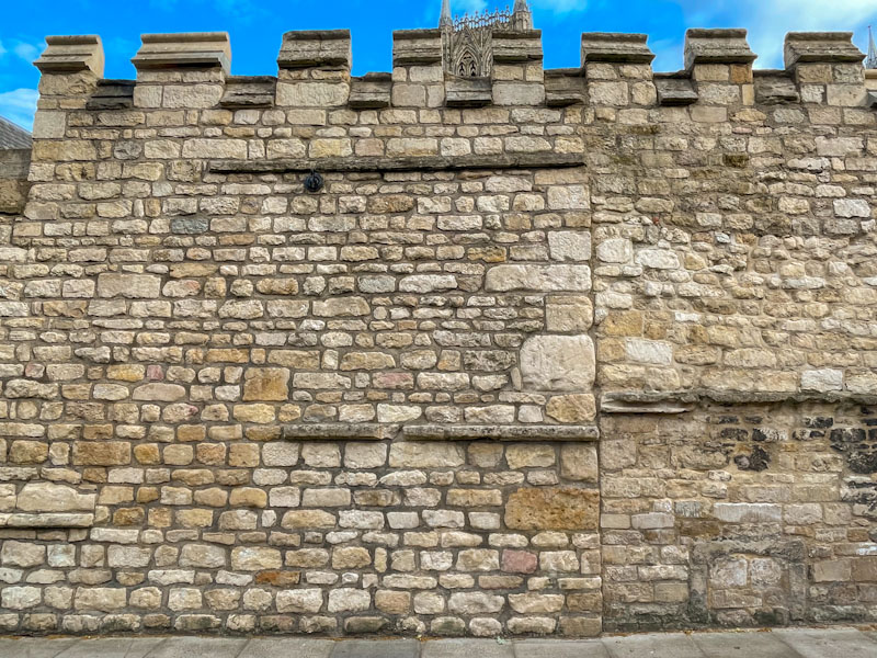 wall with wall repair and is thast a little doorway that has been filled in on the right? Lincoln, July 2023