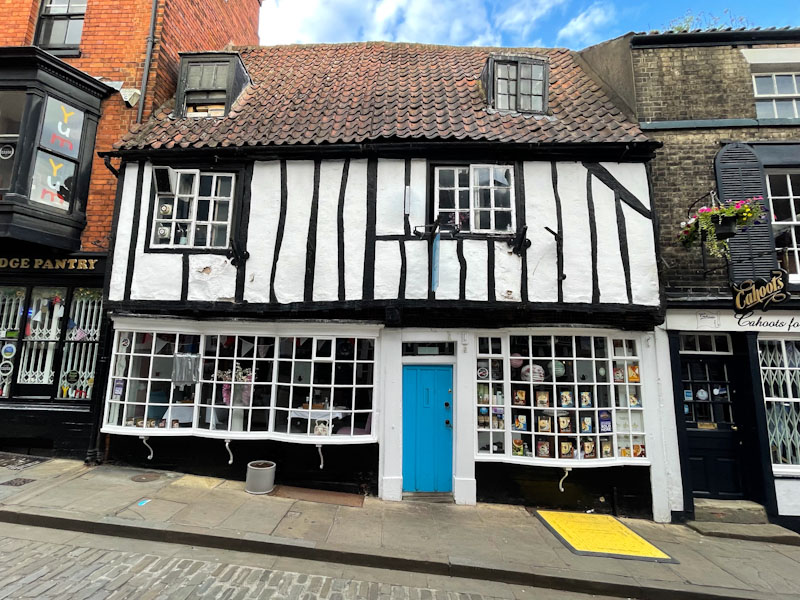 Bright blue door on a timber framed building, Lincoln, July 2023