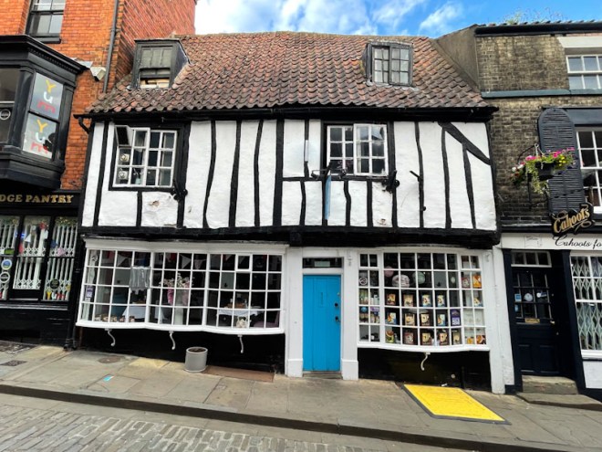 Bright blue door on a timber framed building, Lincoln, July 2023