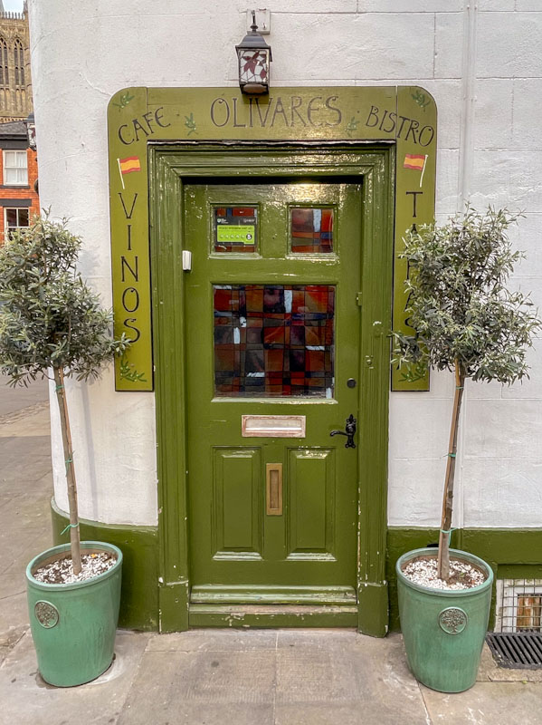 Olive door and olive themed restaurant, Lincoln, July 2023