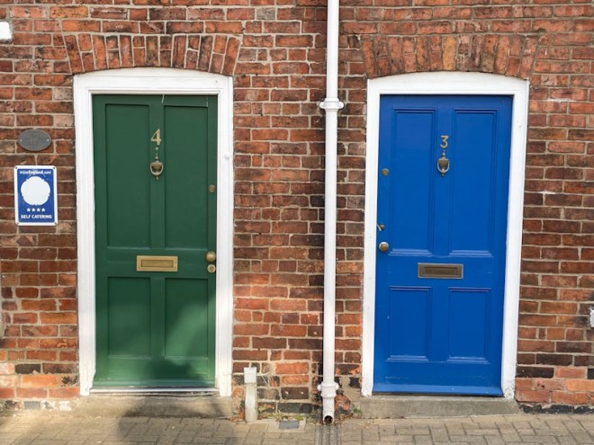 Green and blue pair of doors, Lincoln, July 2023