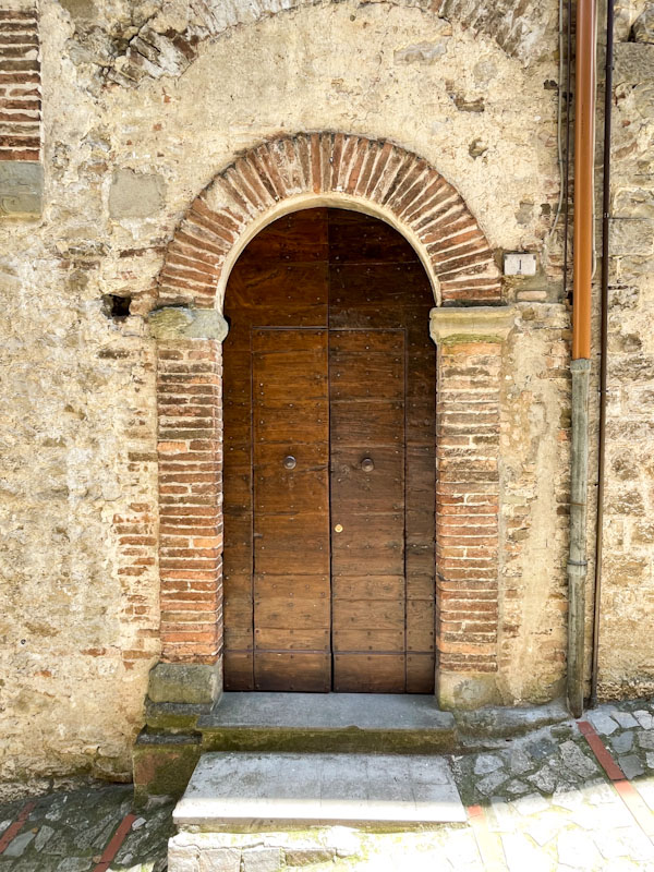 Door panels in an arched doorway, Todi, Umbria, Italy, July 2023