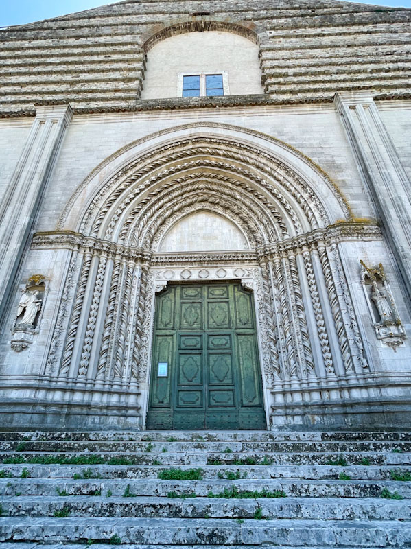 Impressive central door and stonework of Chiesa di San Fortunato, Todi, Umbria, Italy, July 2023