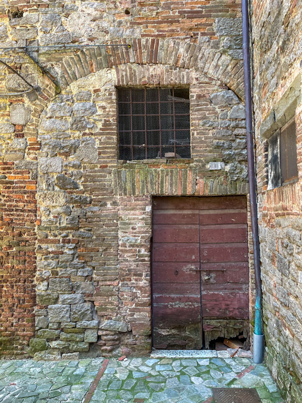 Old door within a large ghost door, Todi, Umbria, Italy, July 2023