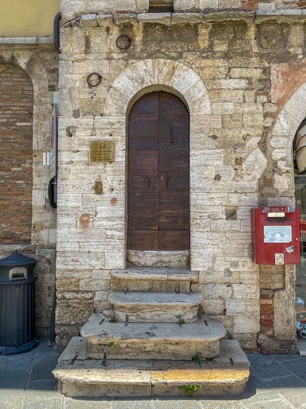 Arched door and impressive stone steps, Todi, Umbria, Italy, July 2023